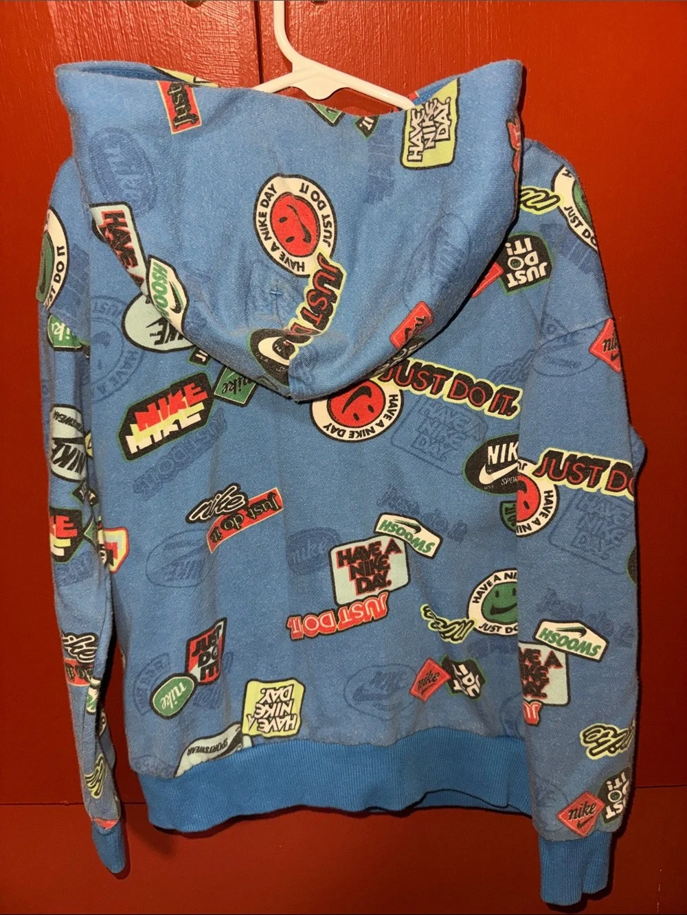 Nike Kids Blue Hoodie with Green Front Pocket and Graphic Badges